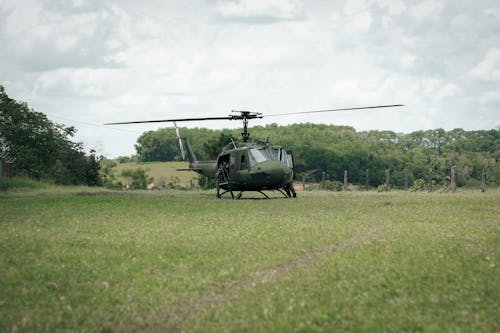 A Green Helicopter on Green Grass Field
