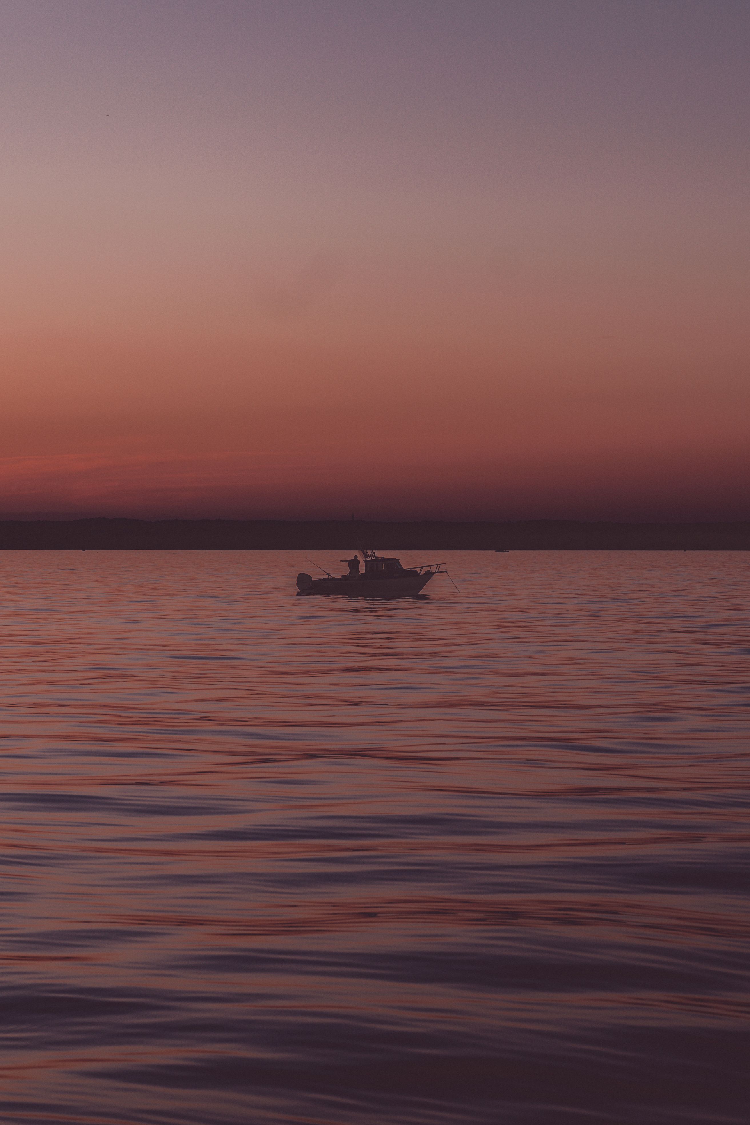Silhouette of Motorboat on Body of Water · Free Stock Photo