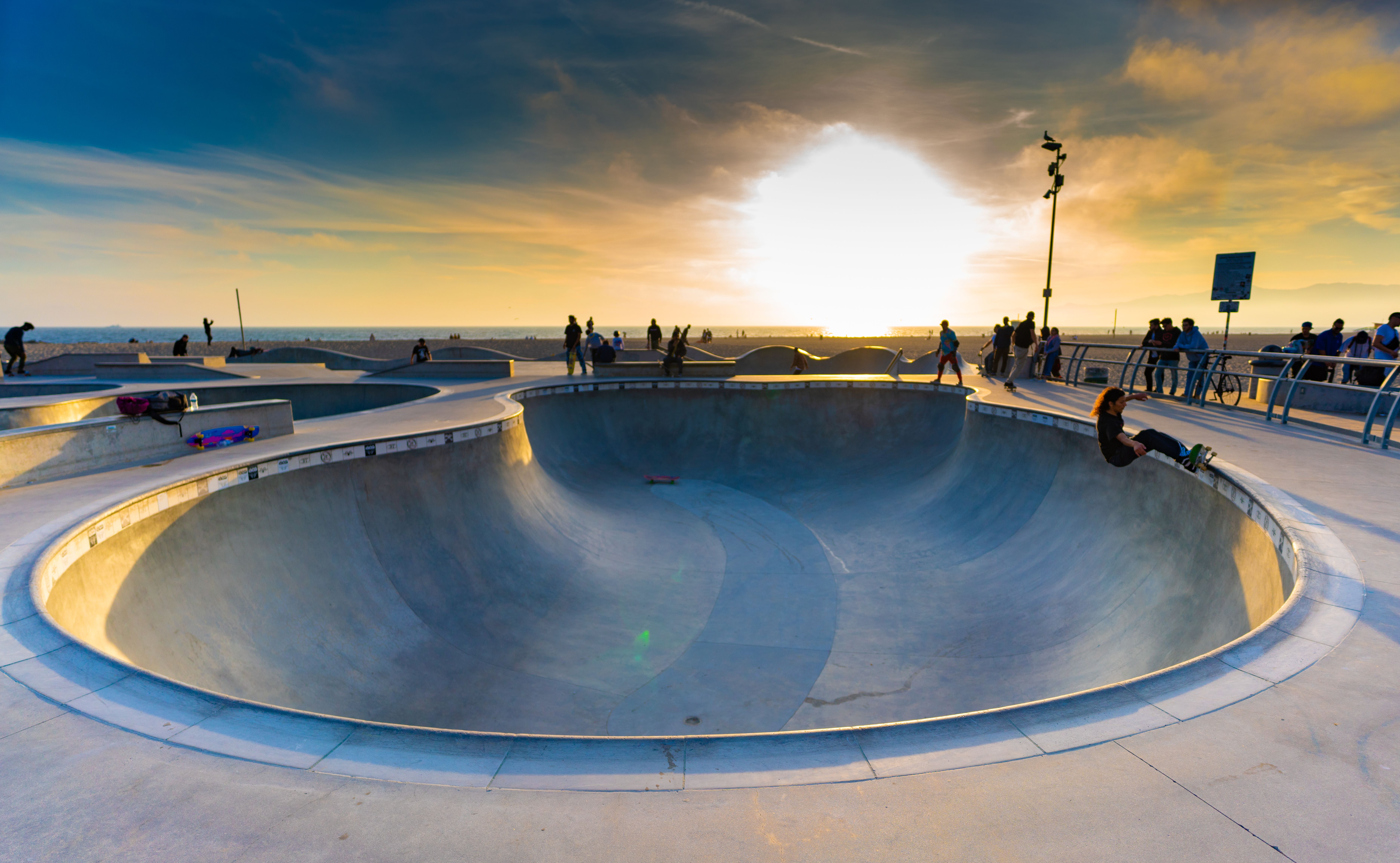 Skateboarder at sunset skatepark
