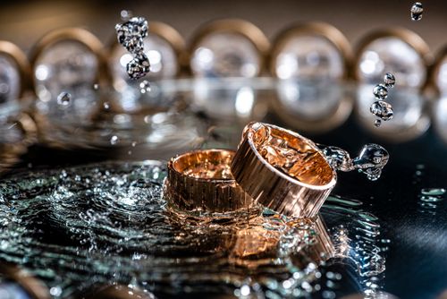Free Close-up of gold rings with water splashes, highlighting luxury and elegance. Stock Photo