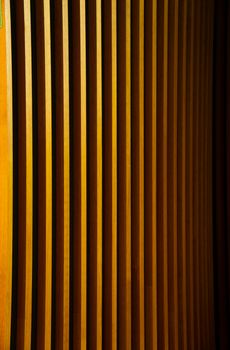 Close-up of vertical wooden slats creating a warm abstract pattern.