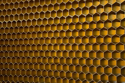 Close-up of a modern hexagonal honeycomb pattern with a warm golden tone.