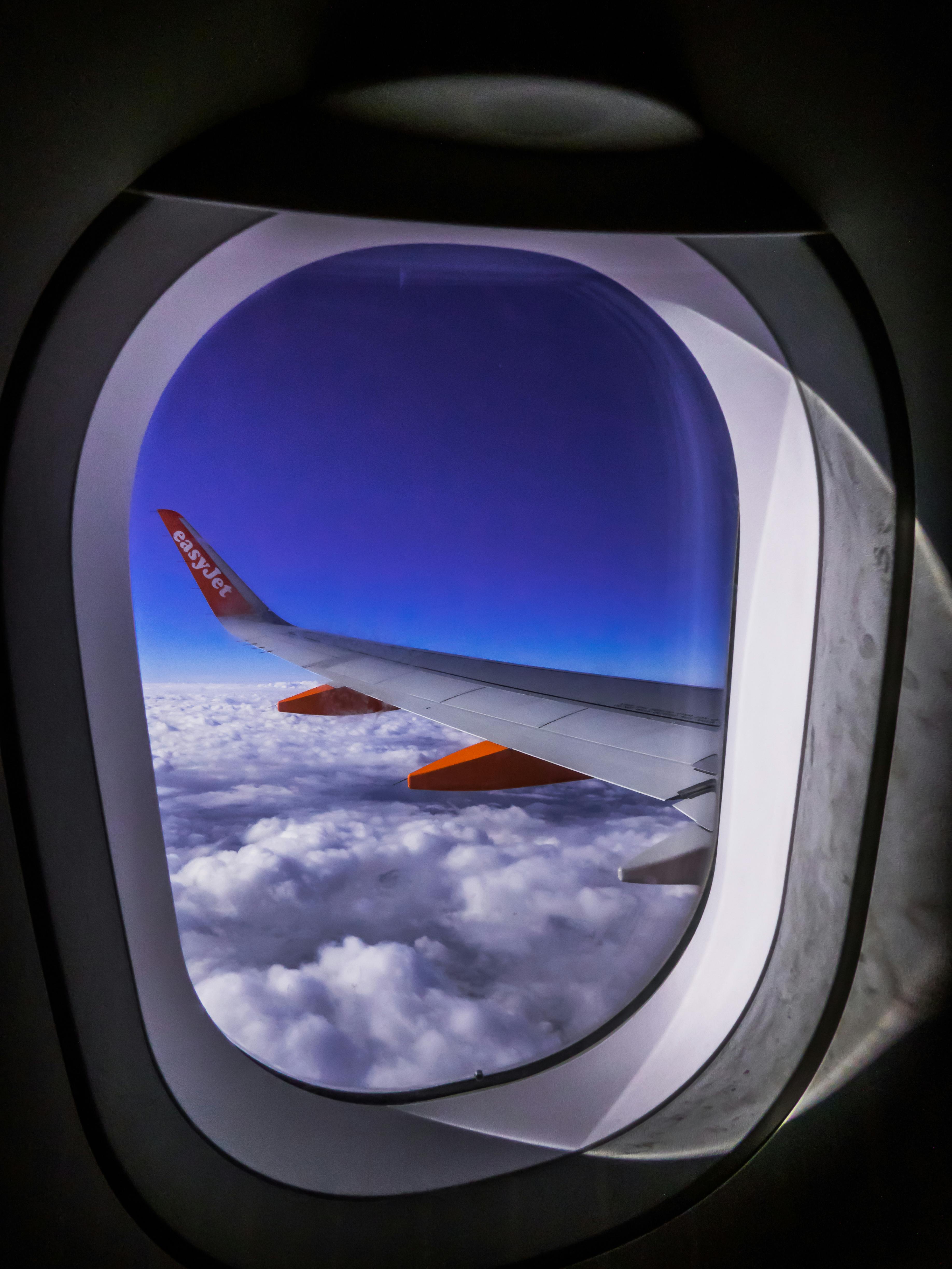 airplane window overlooking clouds