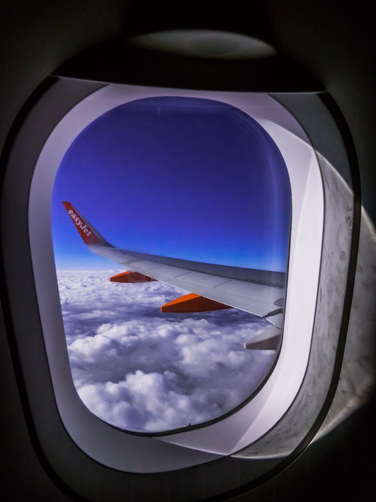 Airplane Window Overlooking Clouds