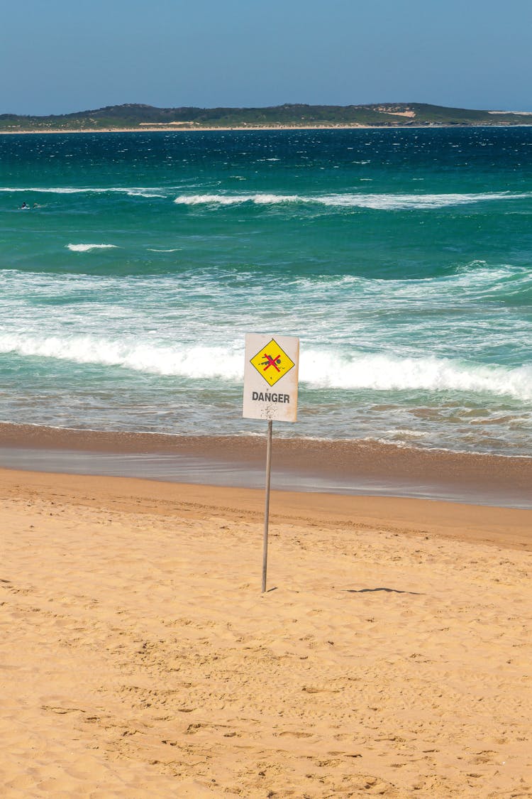 A Danger Sign On A Beach