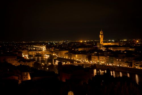 Free Stunning night view of Florence, Italy featuring the illuminated Arno River and city skyline. Stock Photo