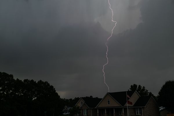 Lightning over a house at night