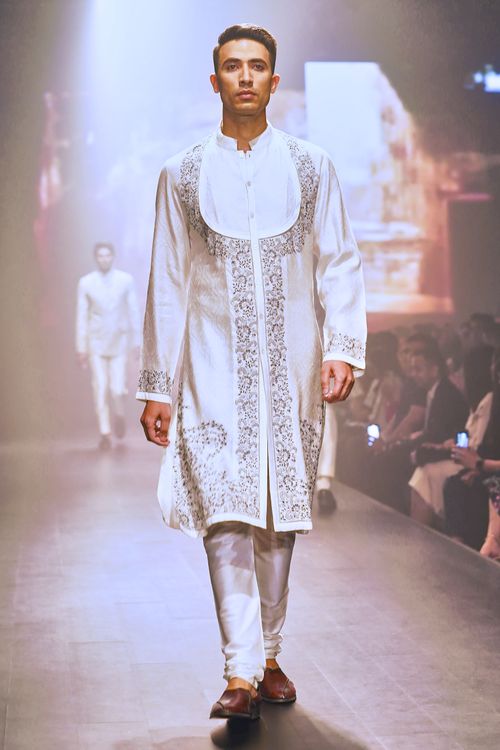 Free Model walking in traditional Indian attire during a fashion show. Stock Photo
