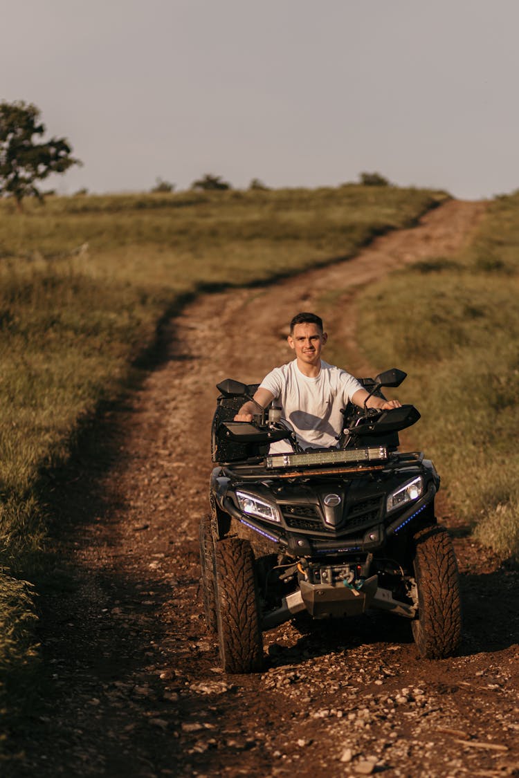 Man Riding A Quad On A Country Road