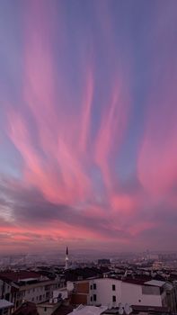Stunning view of Bursa city under a vibrant twilight sky with scenic clouds.