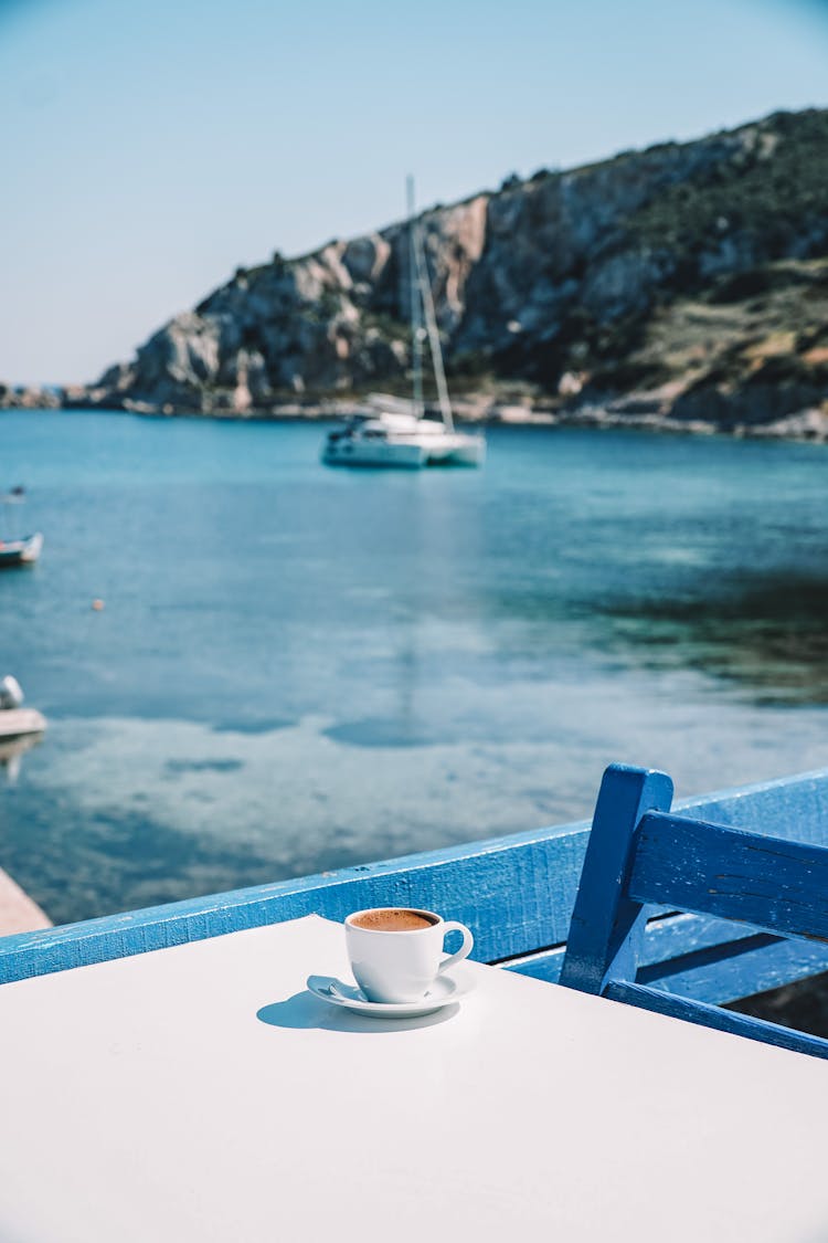 Coffee Cup With View On Yacht In Bay