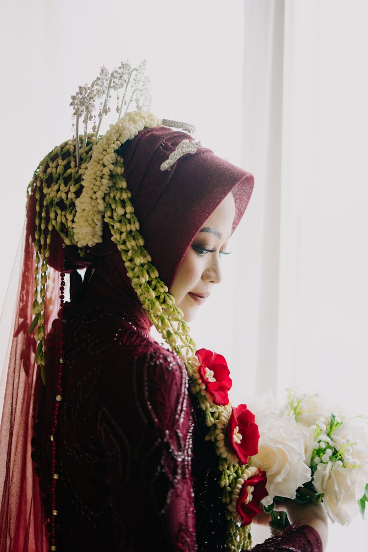 Woman In A Maroon Top With Headscarf And Flower Headband