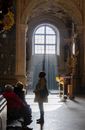 People Inside a Church With Arched Glass Window
