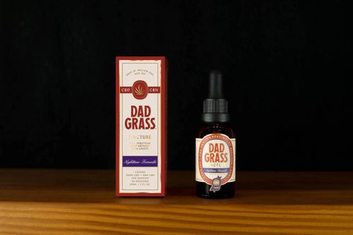Free High-quality still life of Dad Grass CBD tincture highlighting packaging and bottle. Stock Photo