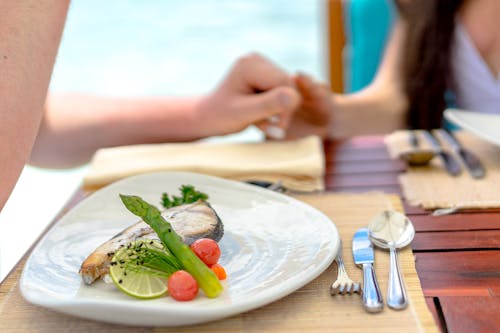 Free Pan Fried Fish Fillet with Asparagus and Cherry Tomatoes on Ceramic Plate Stock Photo