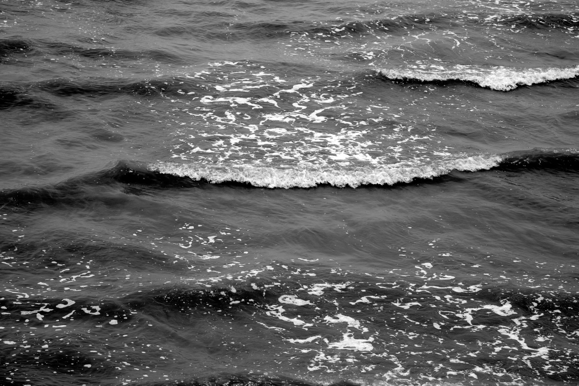 Monochrome photo of ocean waves capturing movement and texture.