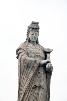 A stunning view of the Mazu statue standing tall against a clear sky, showcasing intricate details and cultural significance.