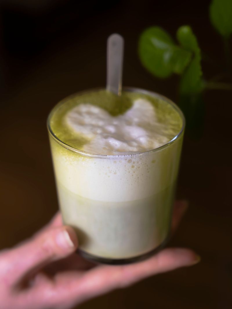 Frothy specialty matcha latte with creamy foam top
