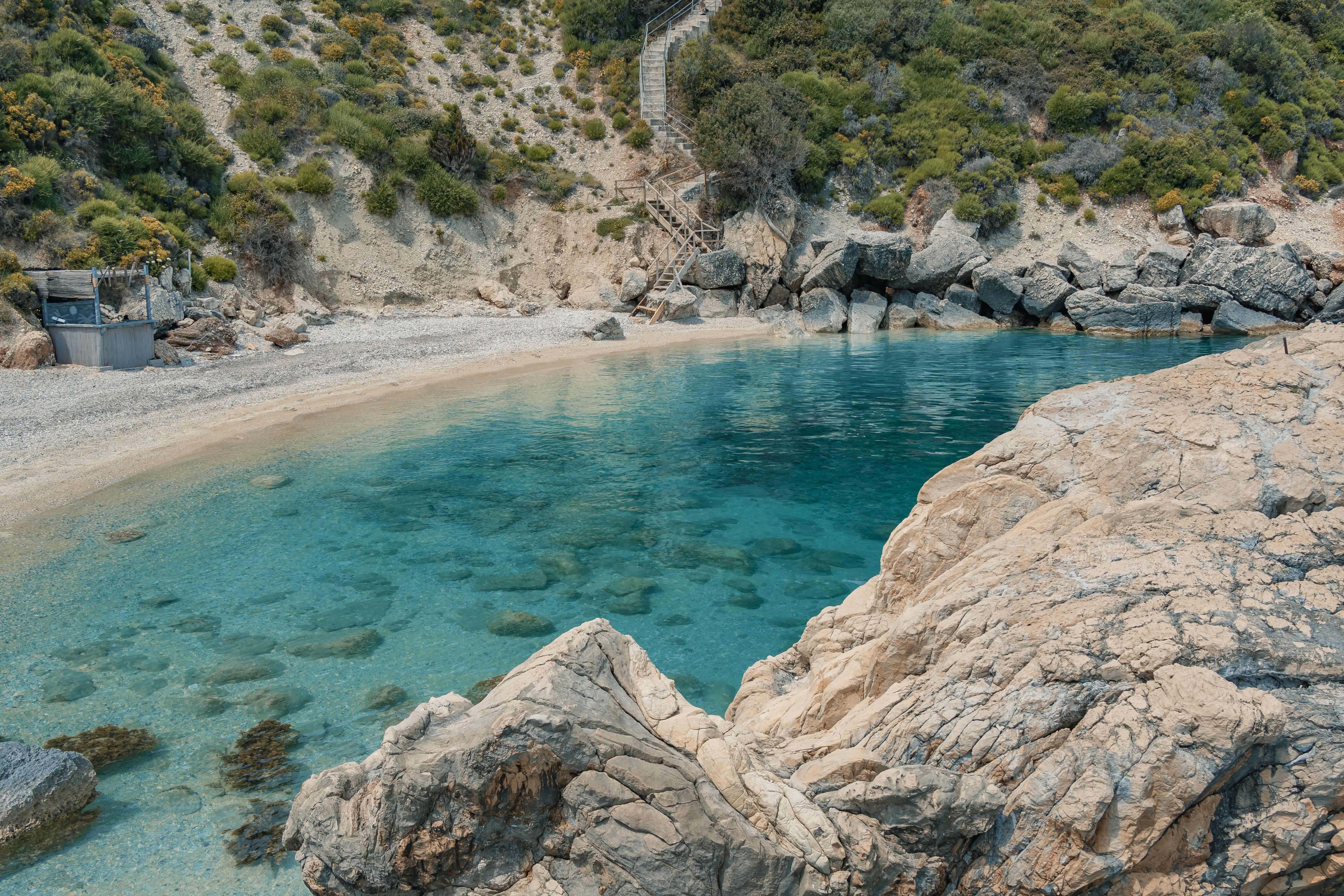 Stunning natural bay in Zakynthos, Greece, with crystal-clear waters and rocky landscape.