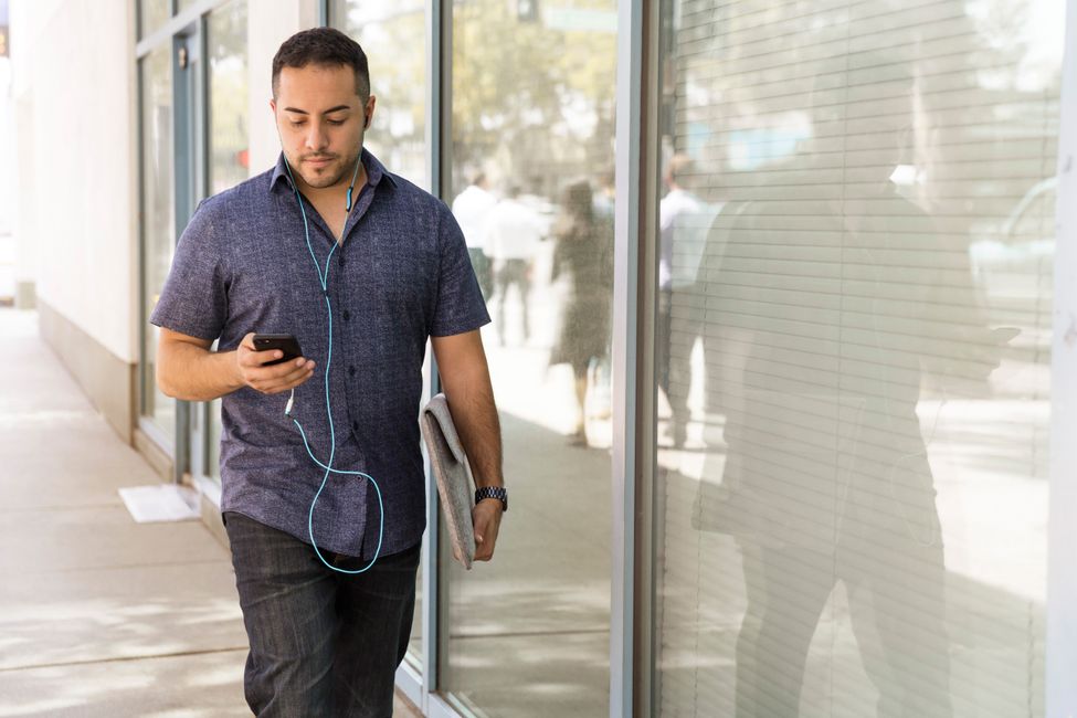 person walking listening outdoors