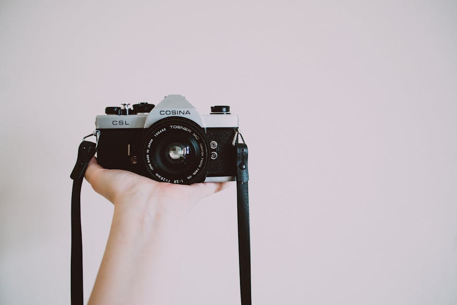 Photography of Person Holding Cosina Camera