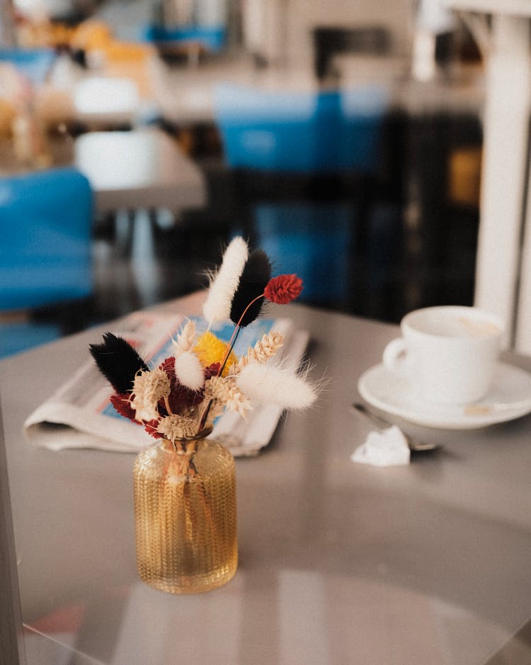 Flowers In Vase On Cafe Table