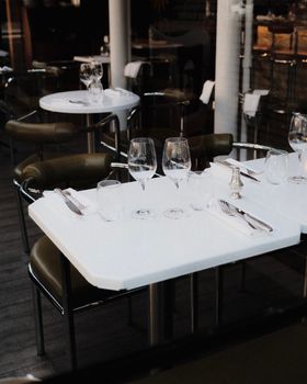 Minimalistic dining scene in an elegant restaurant with glassware and tableware set.