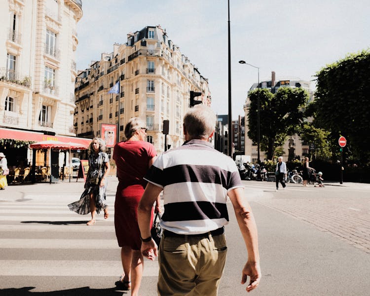 Back Of A Man Walking On A Zebra Crossing