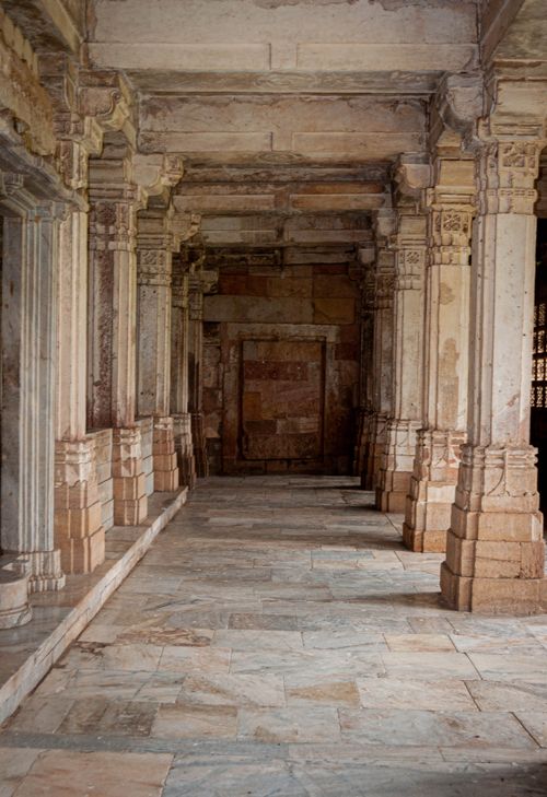 Free Explore the timeless beauty of a classic stone corridor with ornate columns and historical charm. Stock Photo