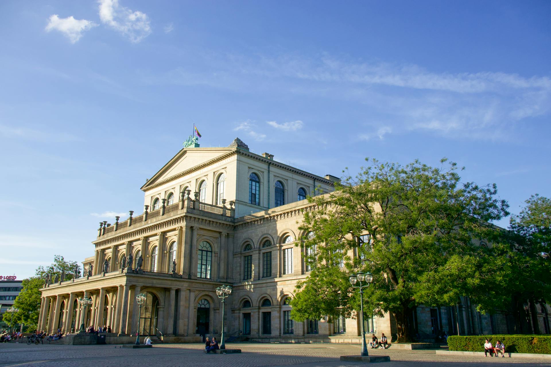 Historic Hannover Opera House with classical architecture in sunny weather, featuring urban surroundings.