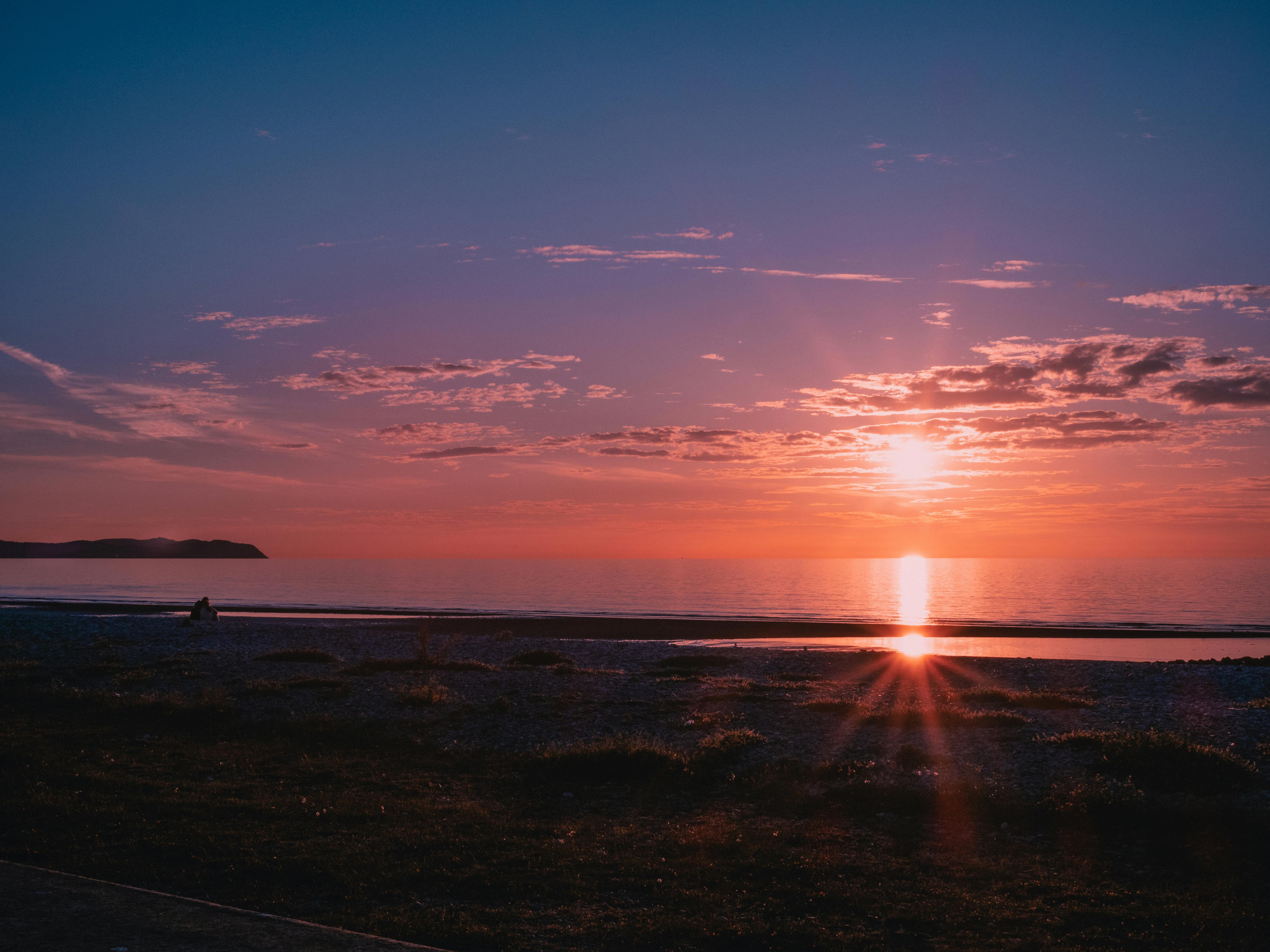 Captivating sunset over Prestatyn beach in Wales, showcasing vibrant colors and serene atmosphere.