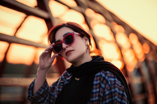 Photo of a Woman Wearing Red Sunglasses