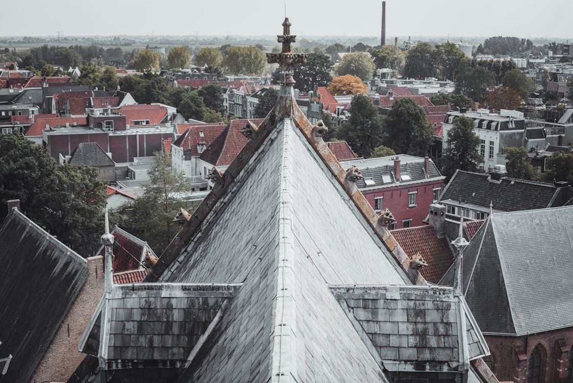 Aerial View of Church Tower and Roofs of Houses