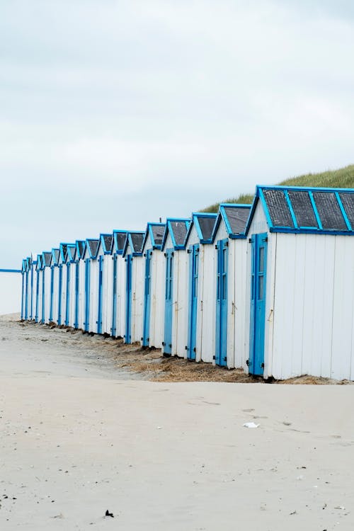 White and Blue Beach Houses on Gray Sand