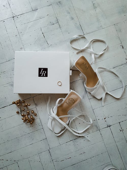 Free White High Heels Beside a Shoebox Stock Photo