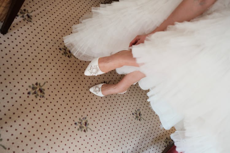 High-Angle Shot Of A Person In White Gown And White Heels