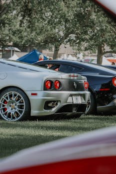 Close-up of sleek luxury sports cars parked outdoor at a car show.