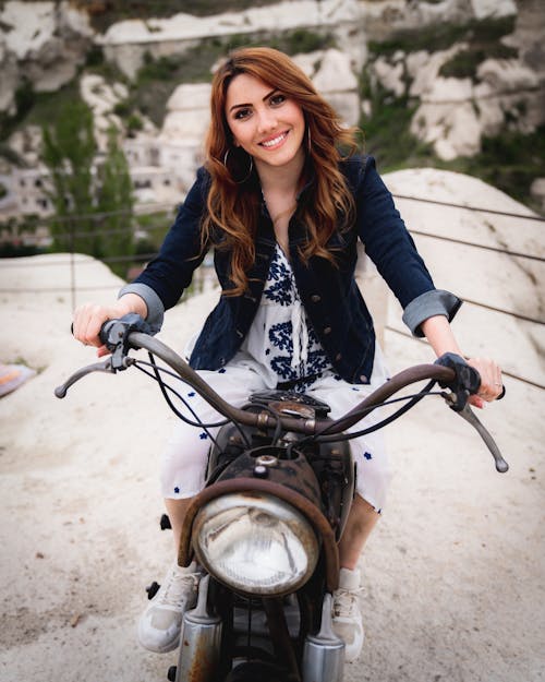 Woman in Denim Jacket Riding Motorcycle