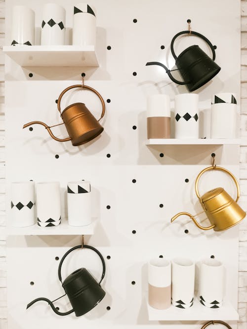 Free Antique Kettles Hanging on a Wall Stock Photo
