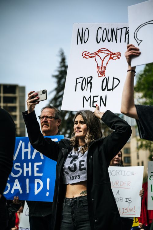 Free A group of people at a rally holding signs advocating for women's rights and reproductive freedom. Stock Photo