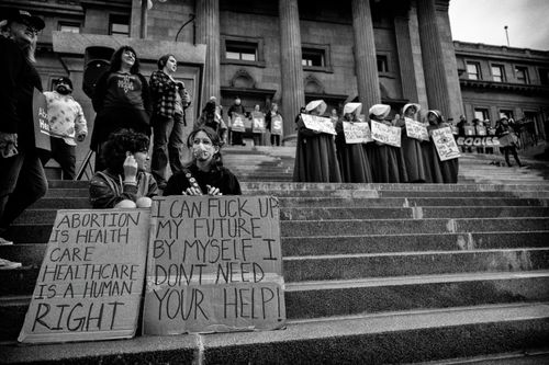 Free A protest featuring people with signs advocating healthcare rights captured on city steps. Stock Photo