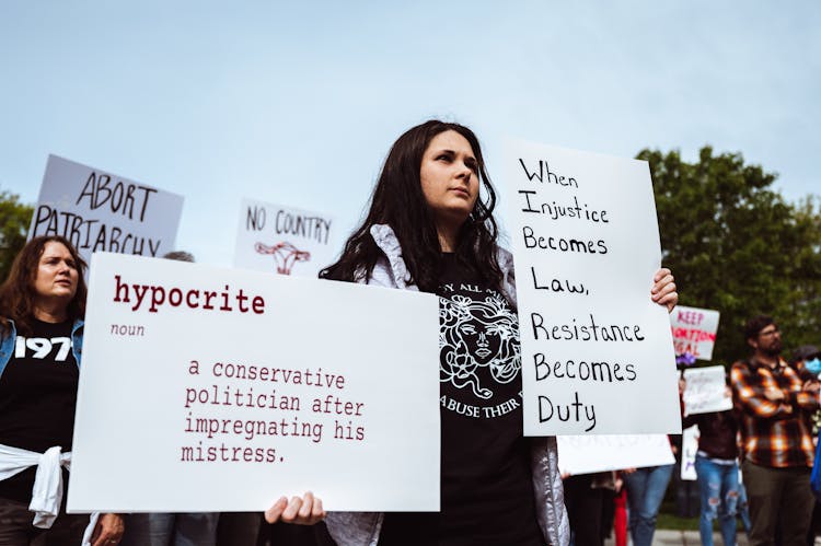 Woman With Signs At Protest