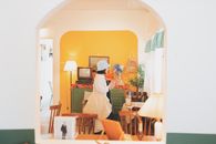 Woman in White Coat in House