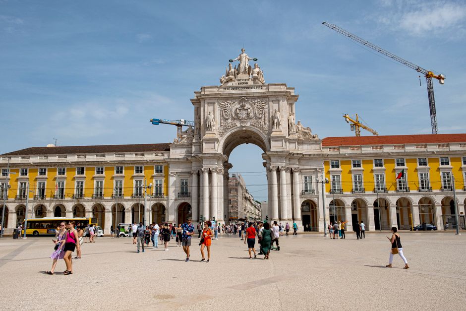 People browsing stalls at Feira da Ladra flea market in Lisbon, Portugal