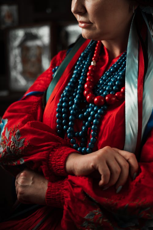 Woman in Red Long Sleeve Top Wearing Necklaces