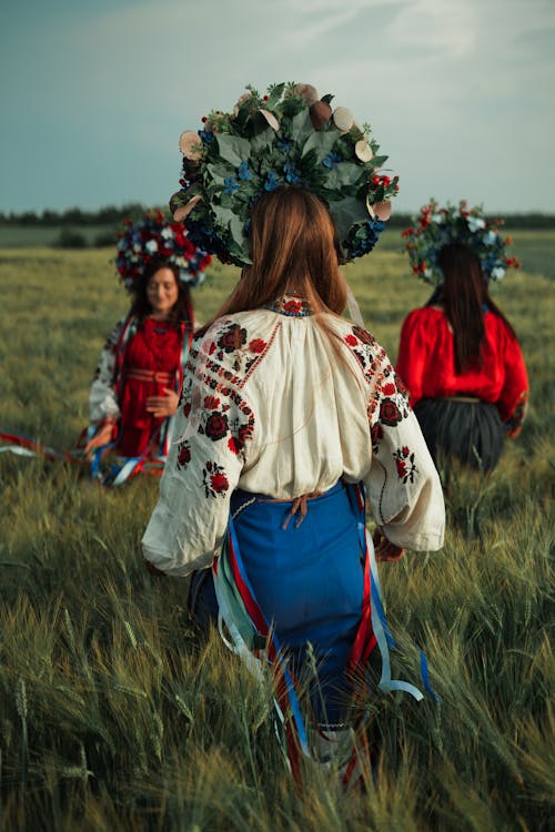 Women in Traditional Clothing on Field