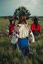 Women in Traditional Clothing on Field