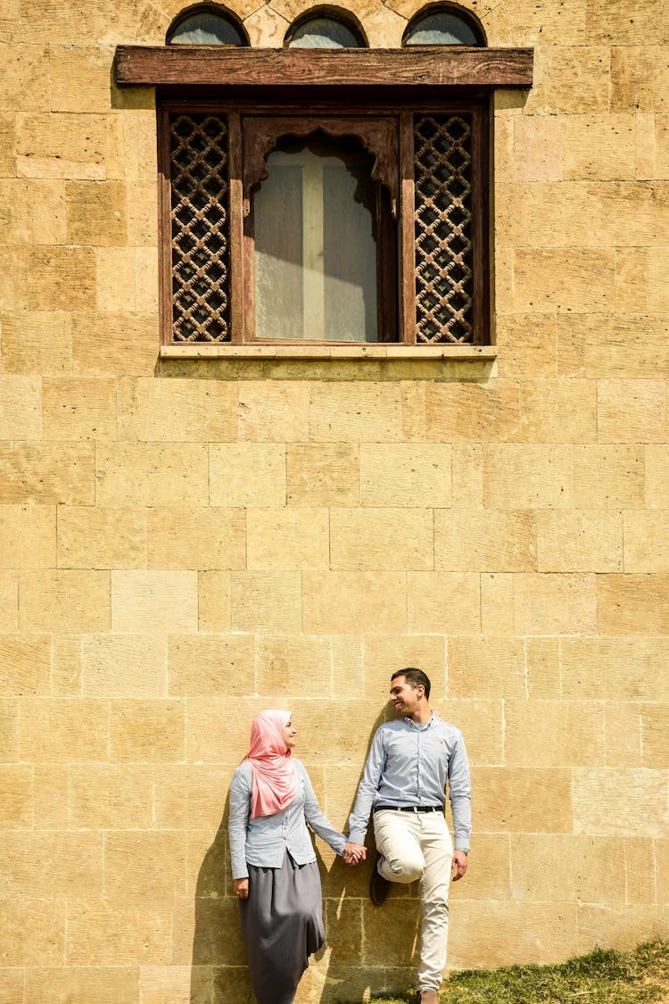 Couple Leaning On The Wall With Window