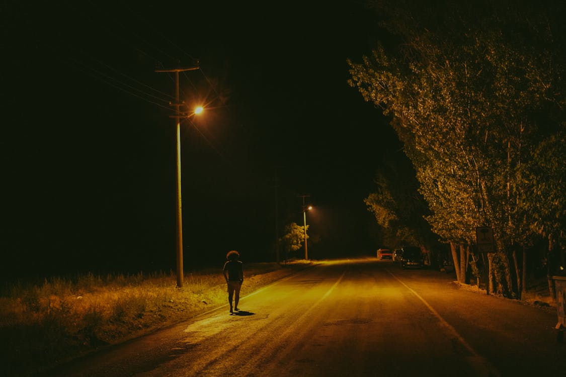 Person Walking on Road during Night Time · Free Stock Photo