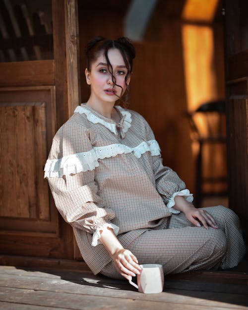 Free A Woman Sitting on the Doorway Stock Photo